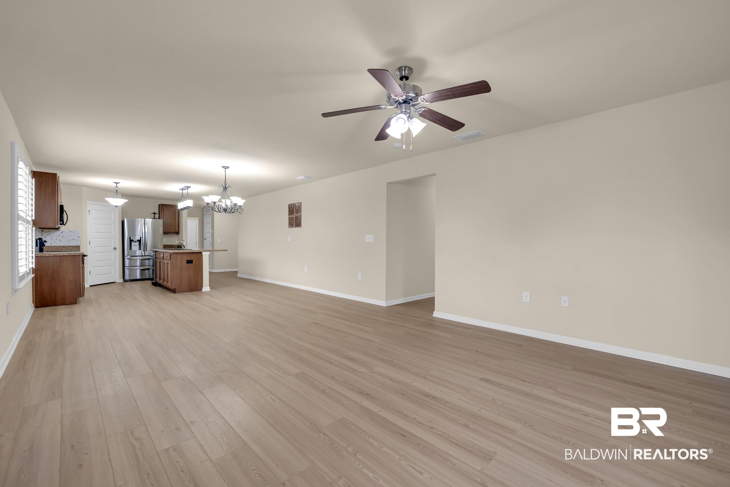 1704 Abbey Loop Foley, AL 36535 - Photo 17 of 38 Spacious open-concept area featuring light wood-finish flooring, recessed lighting, and a ceiling fan