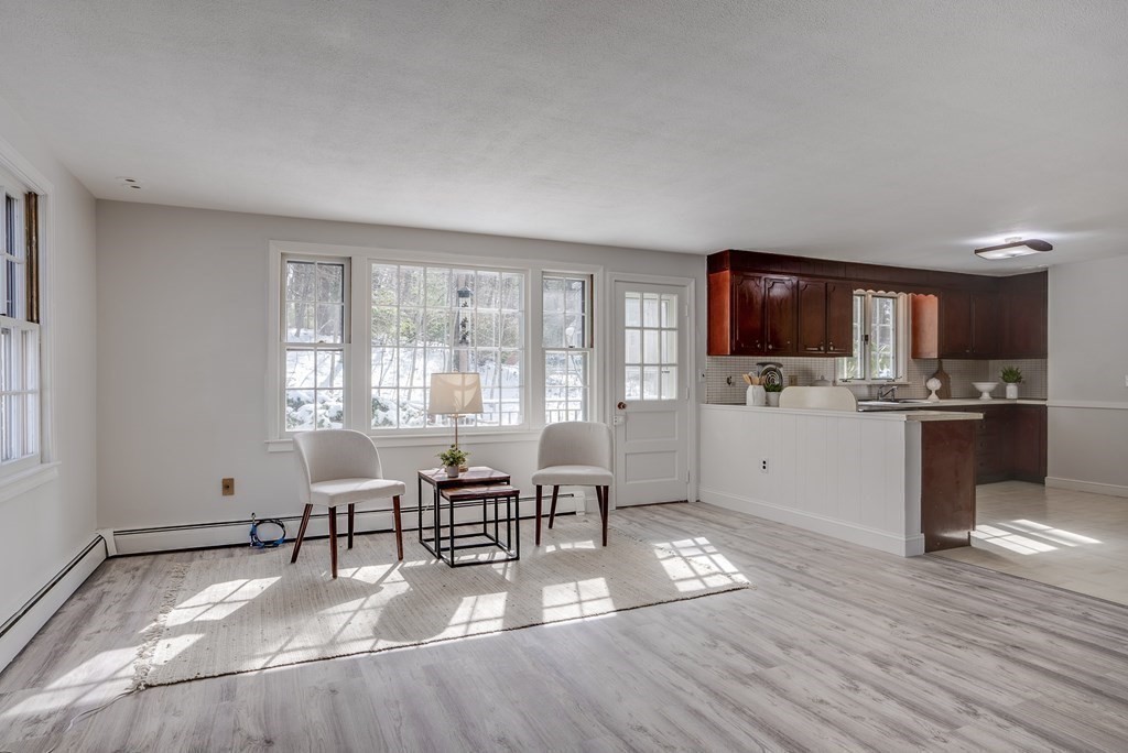 76 Brook Trail Road Concord, MA 01742 - Photo 12 of 33 a living room with furniture a flat screen tv and kitchen view