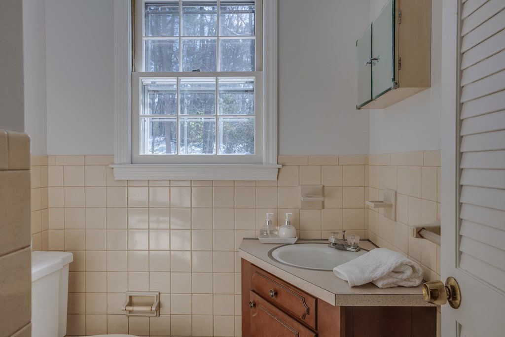 76 Brook Trail Road Concord, MA 01742 - Photo 17 of 33 a bathroom with a sink and a window