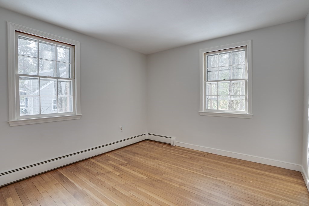 76 Brook Trail Road Concord, MA 01742 - Photo 21 of 33 an empty room with wooden floor and windows