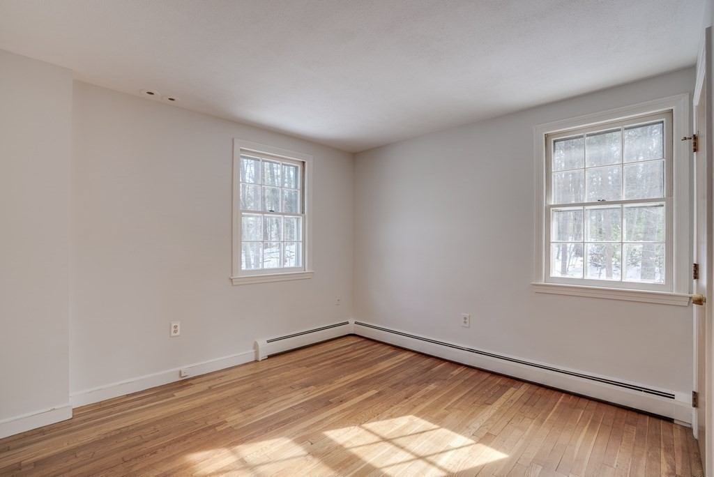 76 Brook Trail Road Concord, MA 01742 - Photo 23 of 33 an empty room with wooden floor and windows