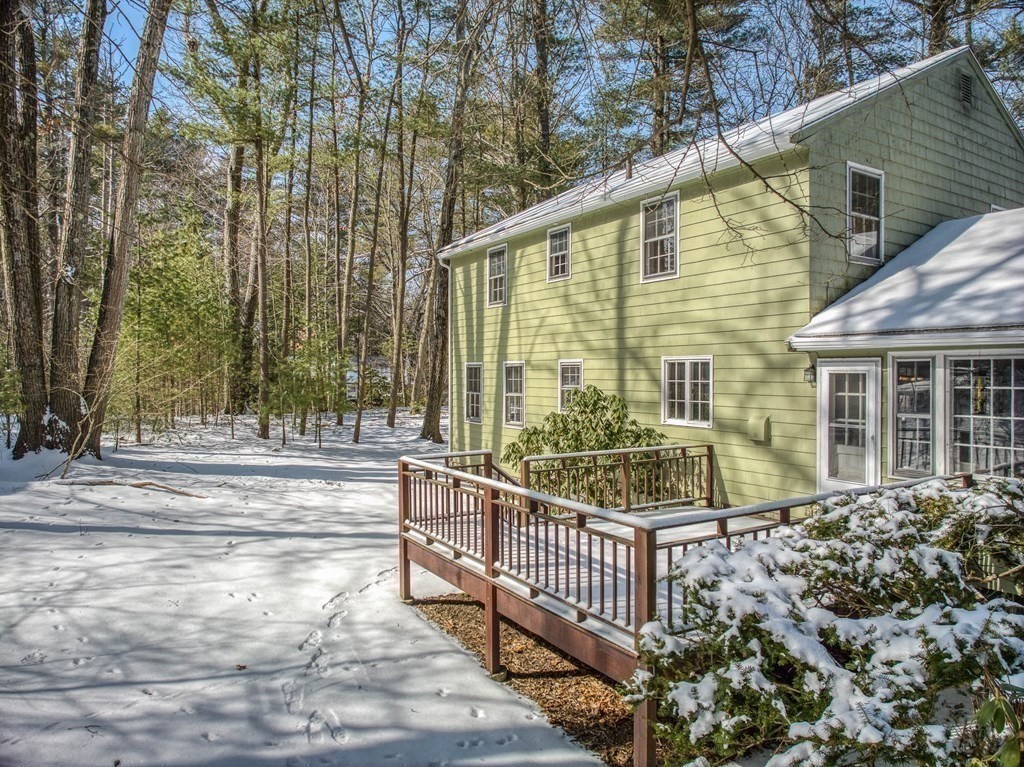76 Brook Trail Road Concord, MA 01742 - Photo 29 of 33 a view of a house with a small yard and wooden fence