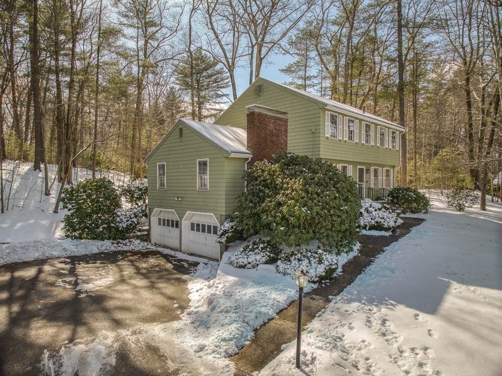 76 Brook Trail Road Concord, MA 01742 - Photo 30 of 33 a view of a house with a yard covered with snow in front of house