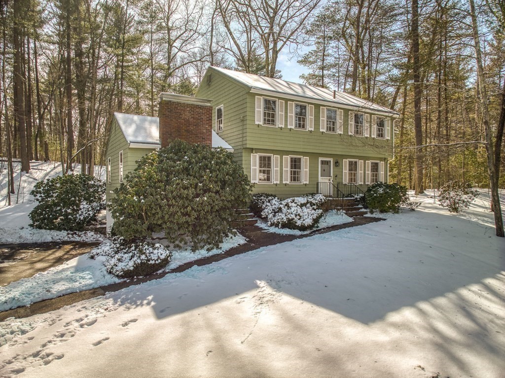 76 Brook Trail Road Concord, MA 01742 - Photo 3 of 33 a view of a house with a yard covered with snow in the background