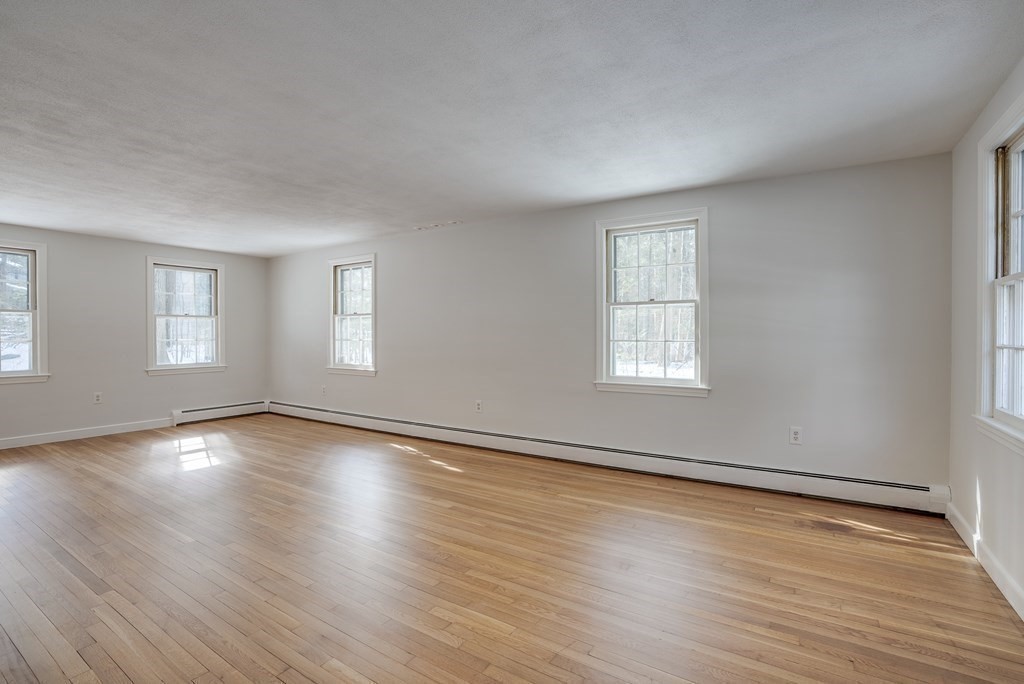 76 Brook Trail Road Concord, MA 01742 - Photo 5 of 33 an empty room with wooden floor and windows