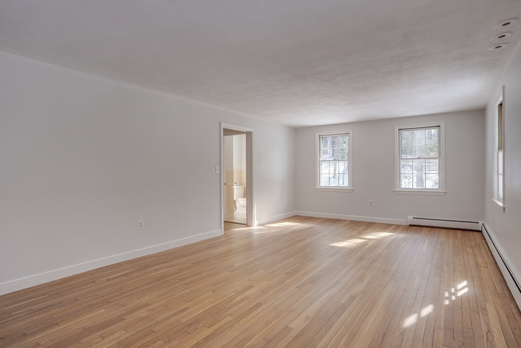 76 Brook Trail Road Concord, MA 01742 - Photo 6 of 33 a view of an empty room with wooden floor and window