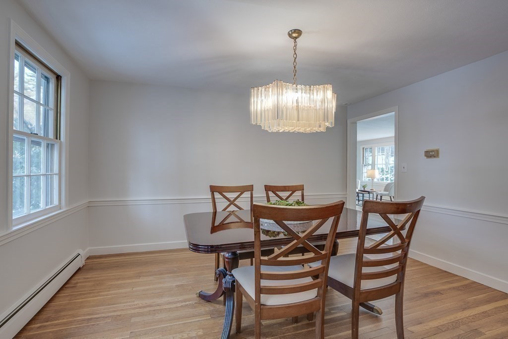 76 Brook Trail Road Concord, MA 01742 - Photo 8 of 33 a view of a dining room with furniture wooden floor and chandelier