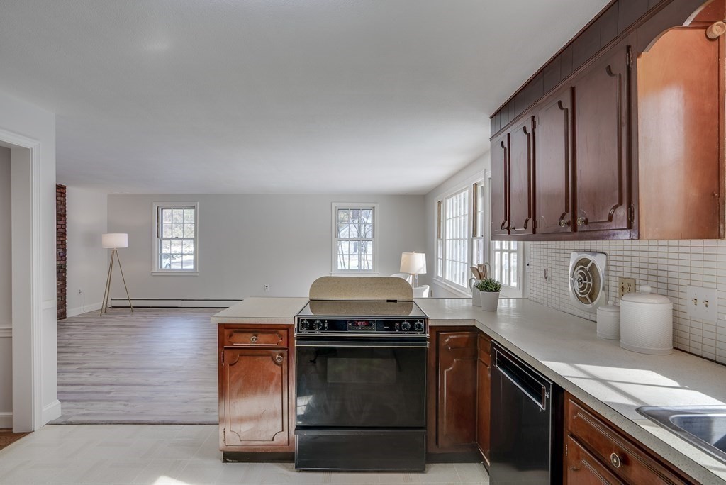 76 Brook Trail Road Concord, MA 01742 - Photo 10 of 33 a kitchen with granite countertop a stove sink and cabinets