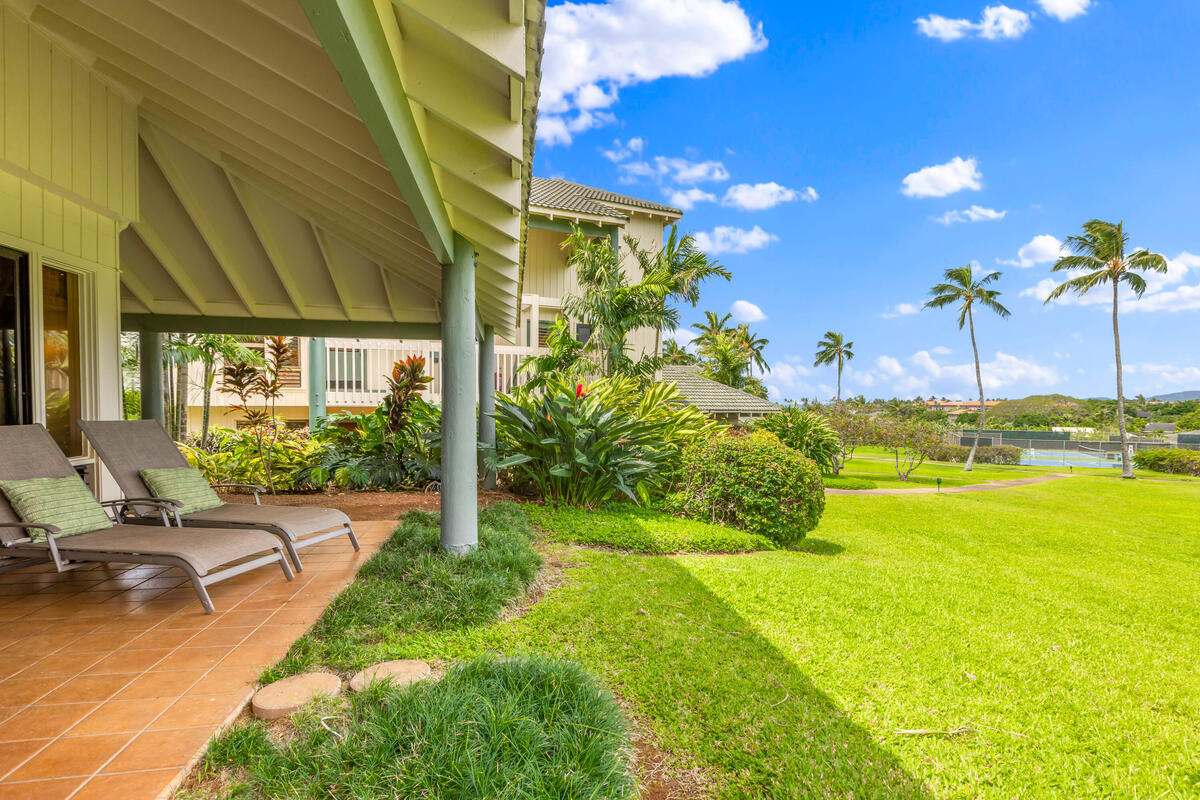 2371 Ho'ohu Road, Unit 801 Koloa, HI 96756 - Photo 11 of 28 a view of a patio with table and chairs potted plants with wooden fence
