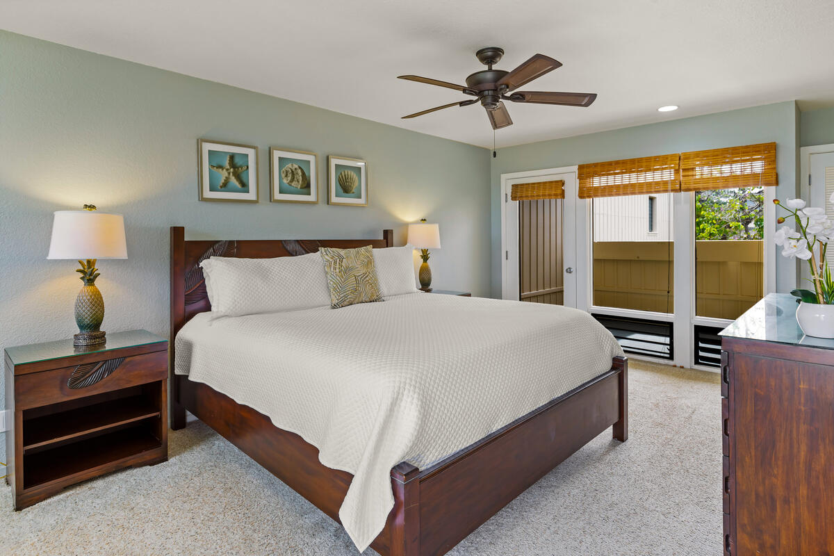 2371 Ho'ohu Road, Unit 801 Koloa, HI 96756 - Photo 18 of 28 a bedroom with a bed and a chandelier