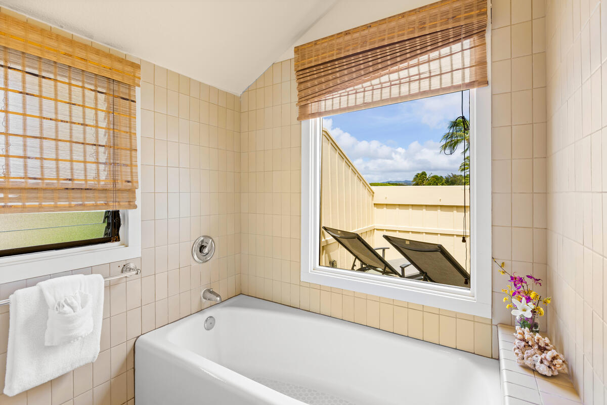 2371 Ho'ohu Road, Unit 801 Koloa, HI 96756 - Photo 19 of 28 a bathroom with a bathtub and a window