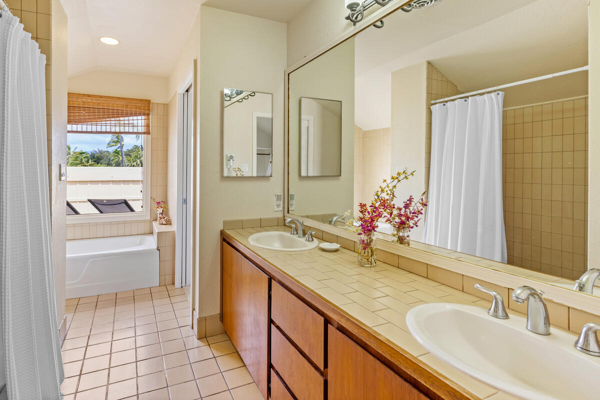 2371 Ho'ohu Road, Unit 801 Koloa, HI 96756 - Photo 20 of 28 a bathroom with a granite countertop sink and a mirror
