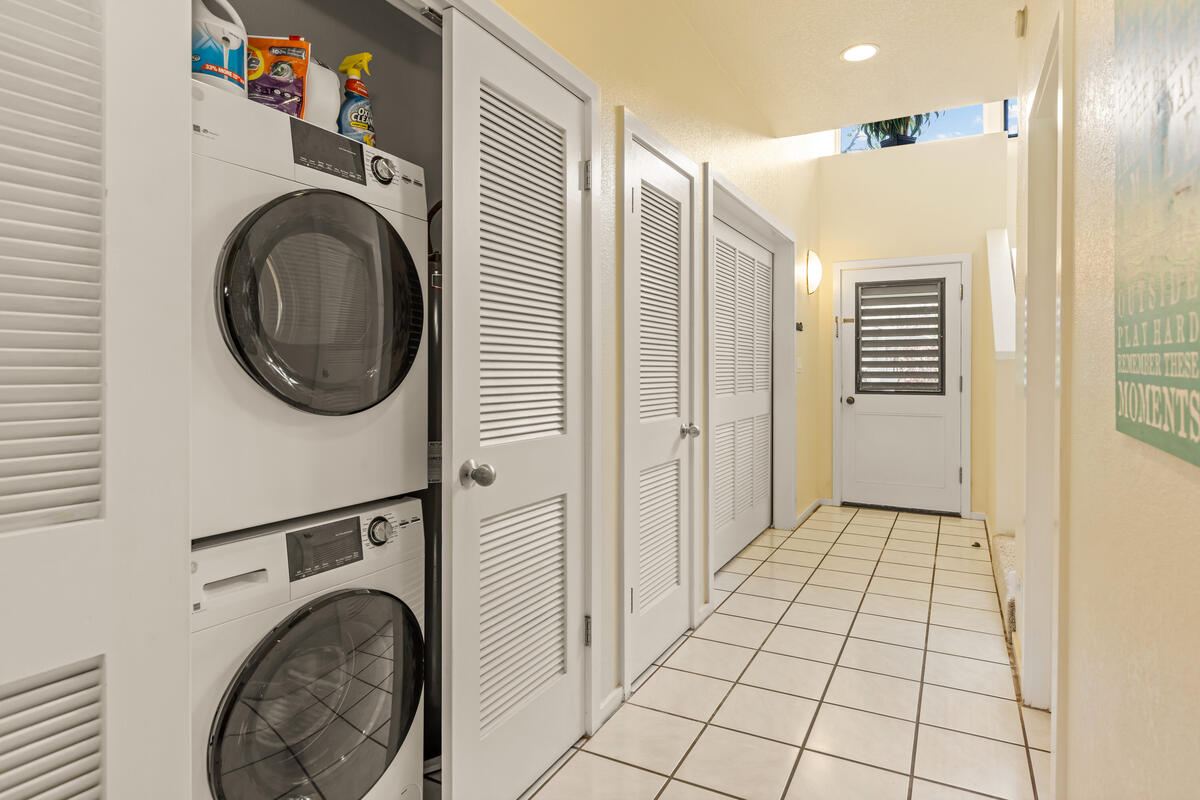 2371 Ho'ohu Road, Unit 801 Koloa, HI 96756 - Photo 22 of 28 a view of a hallway with washer and dryer