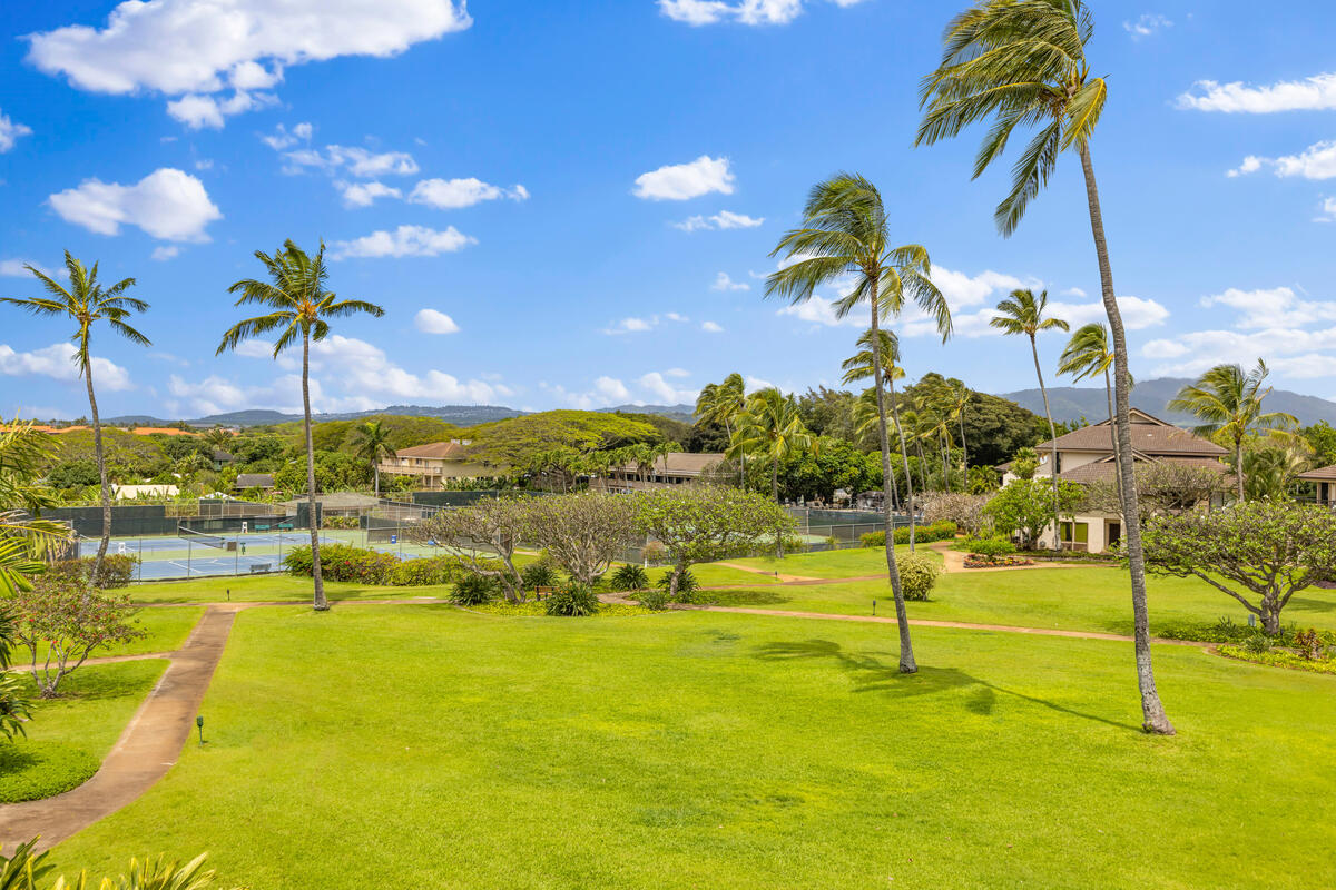 2371 Ho'ohu Road, Unit 801 Koloa, HI 96756 - Photo 25 of 28 a view of a swimming pool with a table and chairs