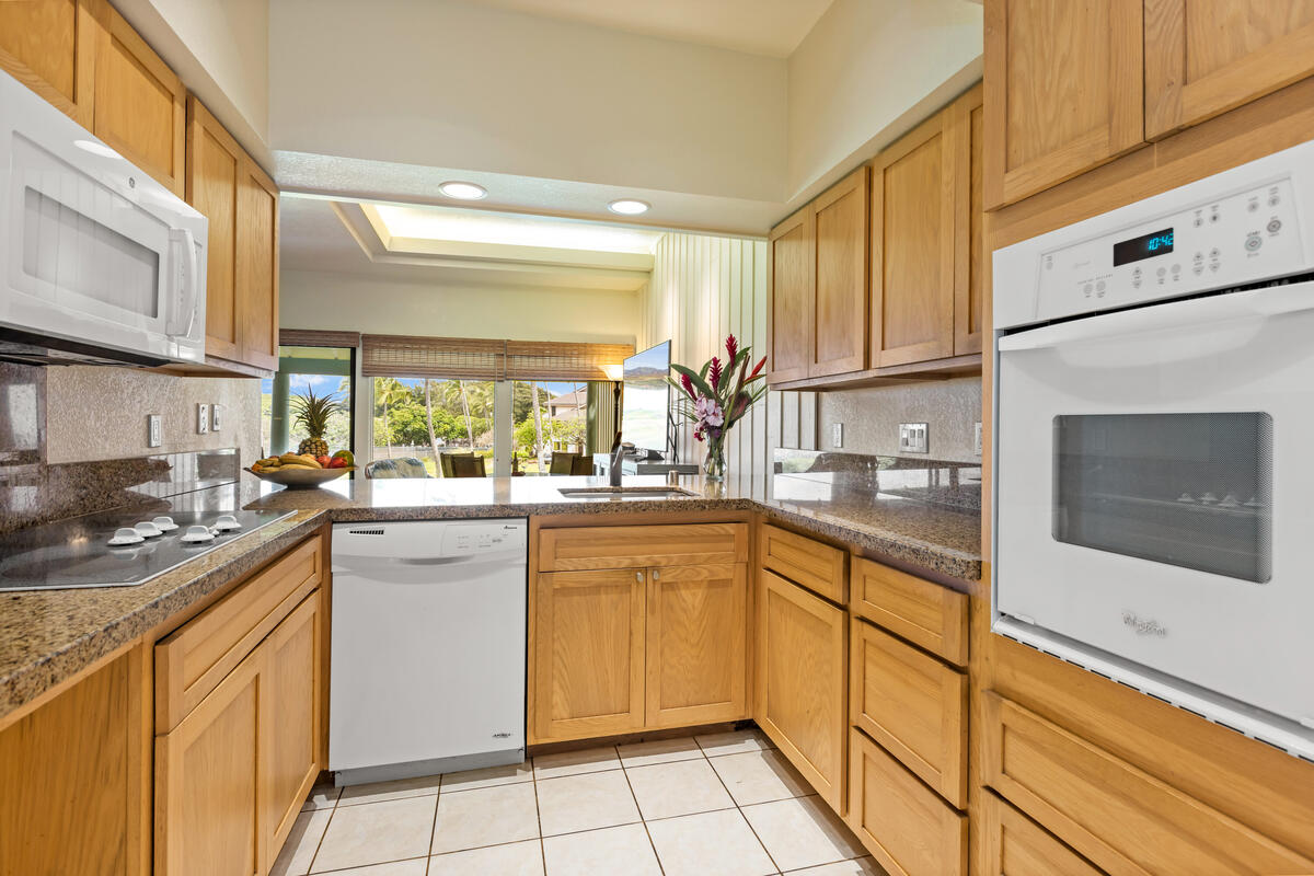 2371 Ho'ohu Road, Unit 801 Koloa, HI 96756 - Photo 6 of 28 a kitchen with a sink cabinets and window