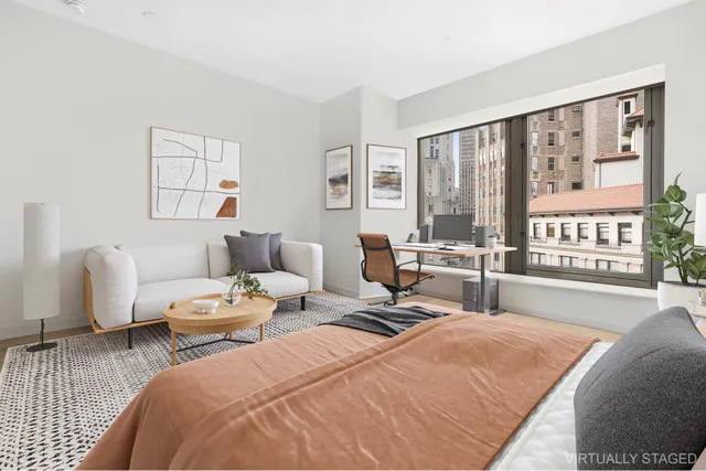 a bedroom with furniture and a large window