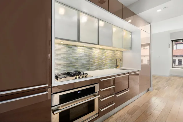 a kitchen with stainless steel appliances a stove and a refrigerator