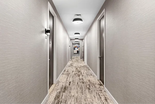 a view of a hallway view with wooden floor and staircase