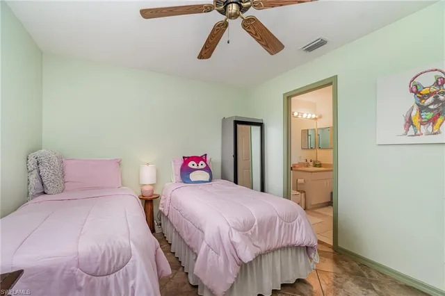 a bedroom with a bed and painting on the wall