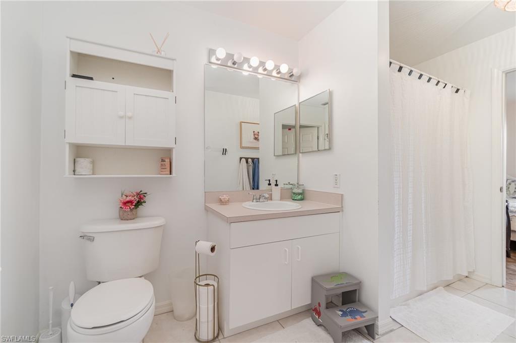 879 Rue Labeau Circle Fort Myers, FL 33913 - Photo 17 of 27 a bathroom with a sink a toilet and a mirror