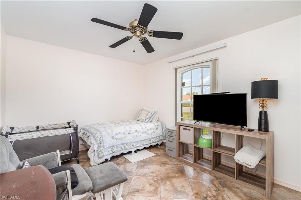 879 Rue Labeau Circle Fort Myers, FL 33913 - Photo 19 of 27 a bedroom with furniture and a flat screen tv