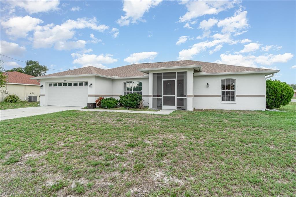 879 Rue Labeau Circle Fort Myers, FL 33913 - Photo 2 of 27 a front view of a house with garden