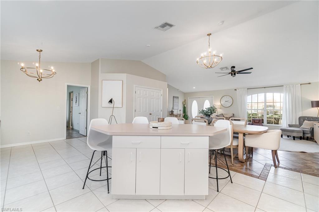 879 Rue Labeau Circle Fort Myers, FL 33913 - Photo 3 of 27 a view of a dining room with furniture and chandelier