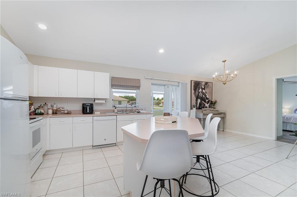 879 Rue Labeau Circle Fort Myers, FL 33913 - Photo 4 of 27 a kitchen with white cabinets and stove