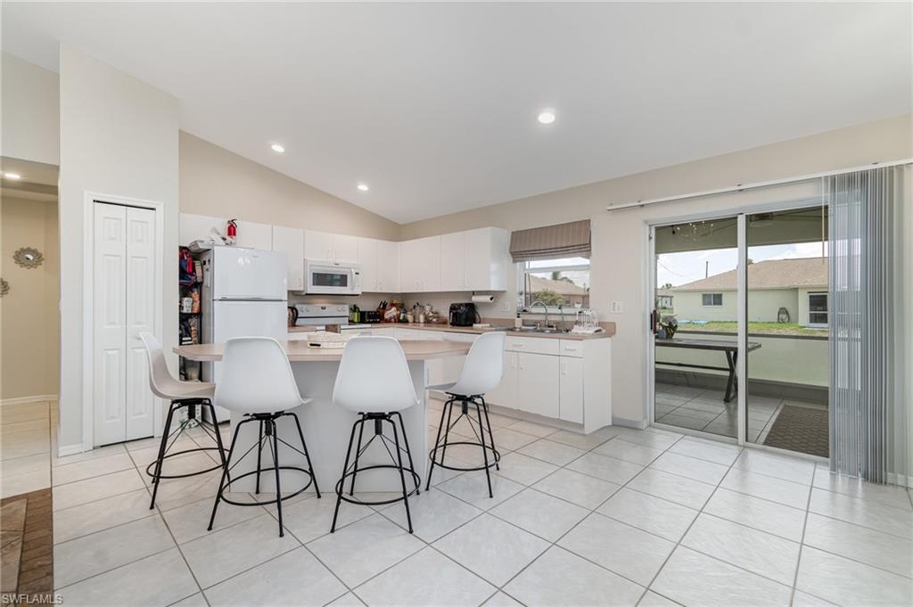 879 Rue Labeau Circle Fort Myers, FL 33913 - Photo 7 of 27 a kitchen with a sink cabinets and chairs