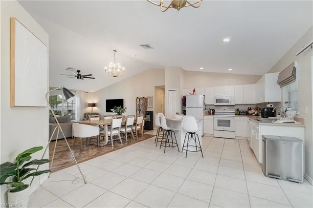 a living room with furniture a dining table and kitchen view