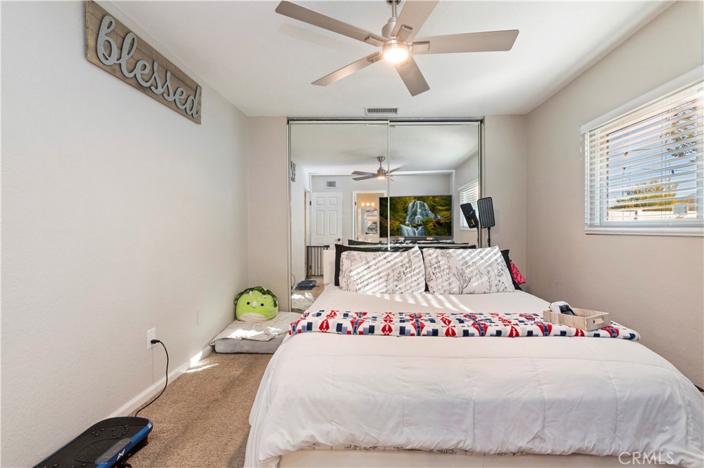 25143 Sugar Hill Road Moreno Valley, CA 92553 - Photo 18 of 28 a large white bed sitting in a bedroom next to a window