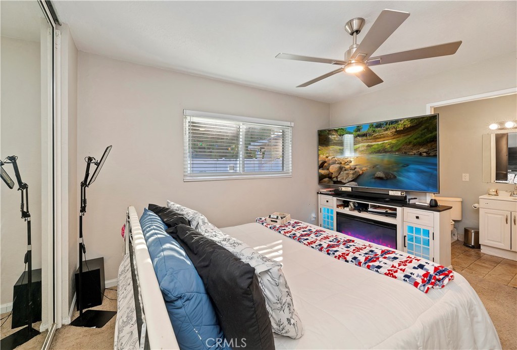 25143 Sugar Hill Road Moreno Valley, CA 92553 - Photo 19 of 28 a bedroom with a bed and a flat screen tv