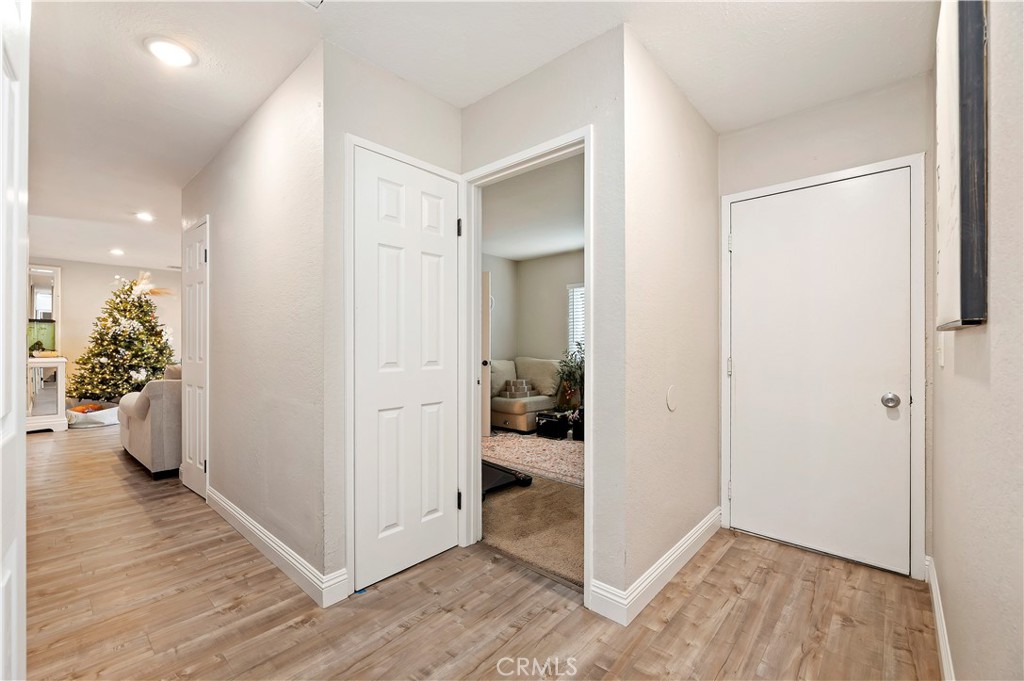 25143 Sugar Hill Road Moreno Valley, CA 92553 - Photo 21 of 28 a view of a hallway with bathroom and wooden floor