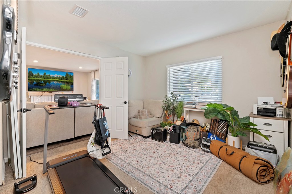 25143 Sugar Hill Road Moreno Valley, CA 92553 - Photo 22 of 28 a room with gym equipment and a window