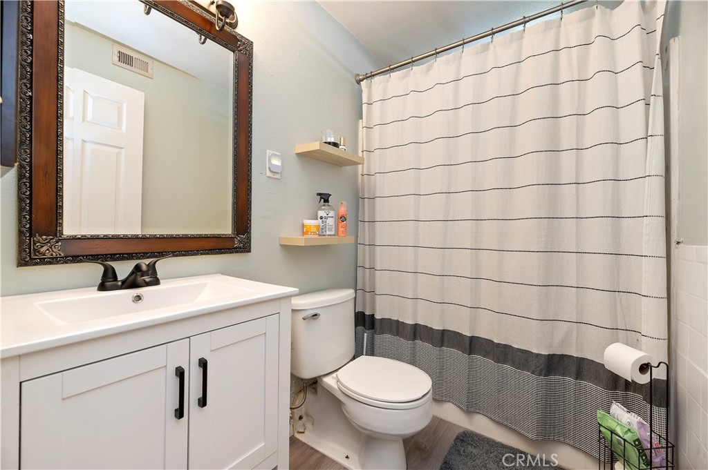 25143 Sugar Hill Road Moreno Valley, CA 92553 - Photo 24 of 28 a bathroom with a sink toilet and shower