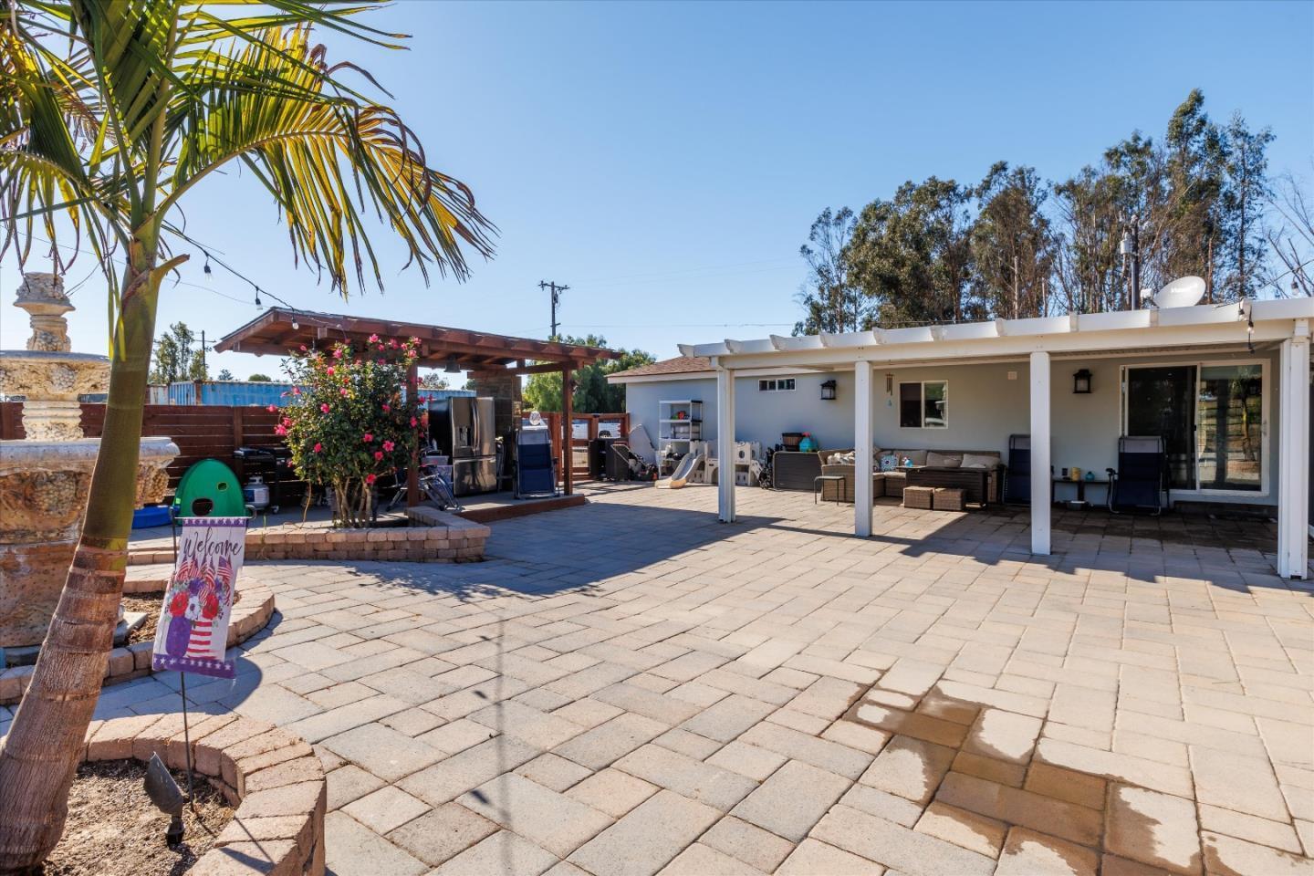 840 South Oak Glen Avenue Nipomo, CA 93444 - Photo 13 of 21 a view of a patio with a table and chairs under an umbrella