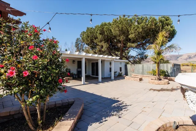 a view of a house with a yard and a tree