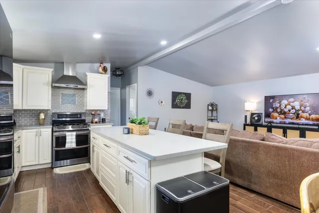 a view of kitchen with sink stove and refrigerator