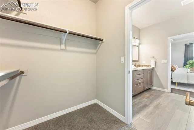 a bed room with a bed and a white wall