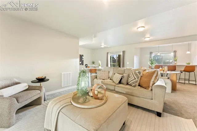 a view of a big house with a big yard and large tree