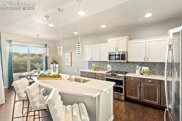 a view of a dining room with a table and chairs