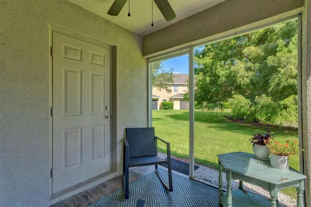 a view of a porch with furniture and garden