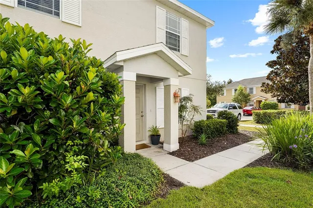 a view of a house with a yard and plants