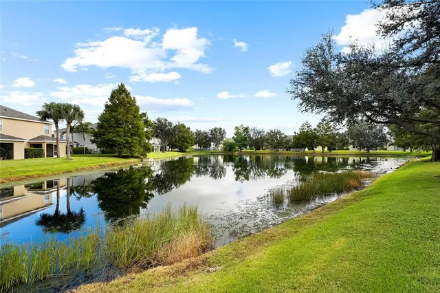 an aerial view of a house with a yard and lake view