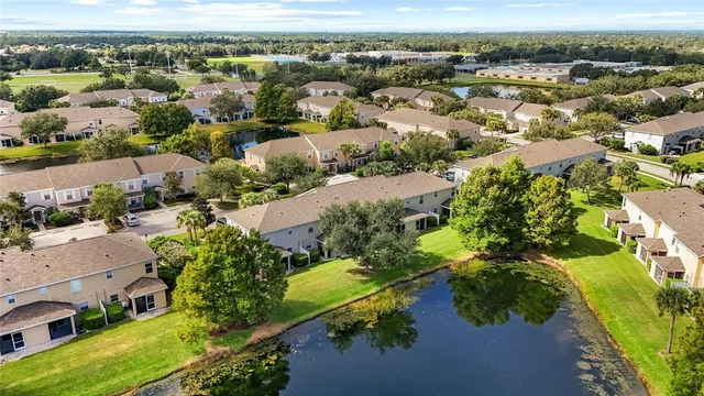 an aerial view of residential houses with outdoor space and street view