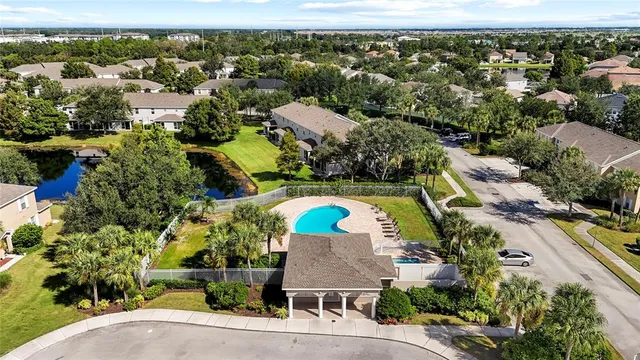 a view of a house with large windows and a small yard