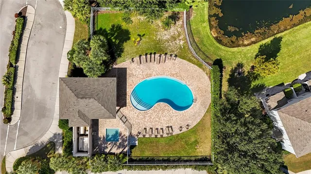 a view of a swimming pool with a yard