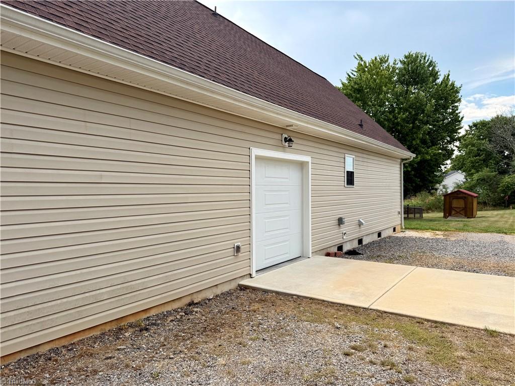 1027 Tabor Road Olin, NC 28660 - Photo 39 of 43 side garage door, concrete pad, camper hookup