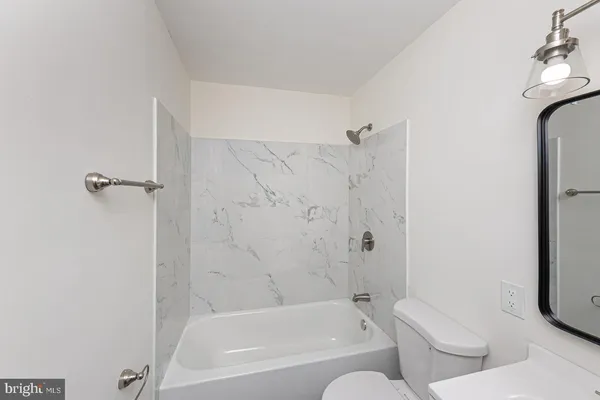 a bathroom with a bathtub and shower