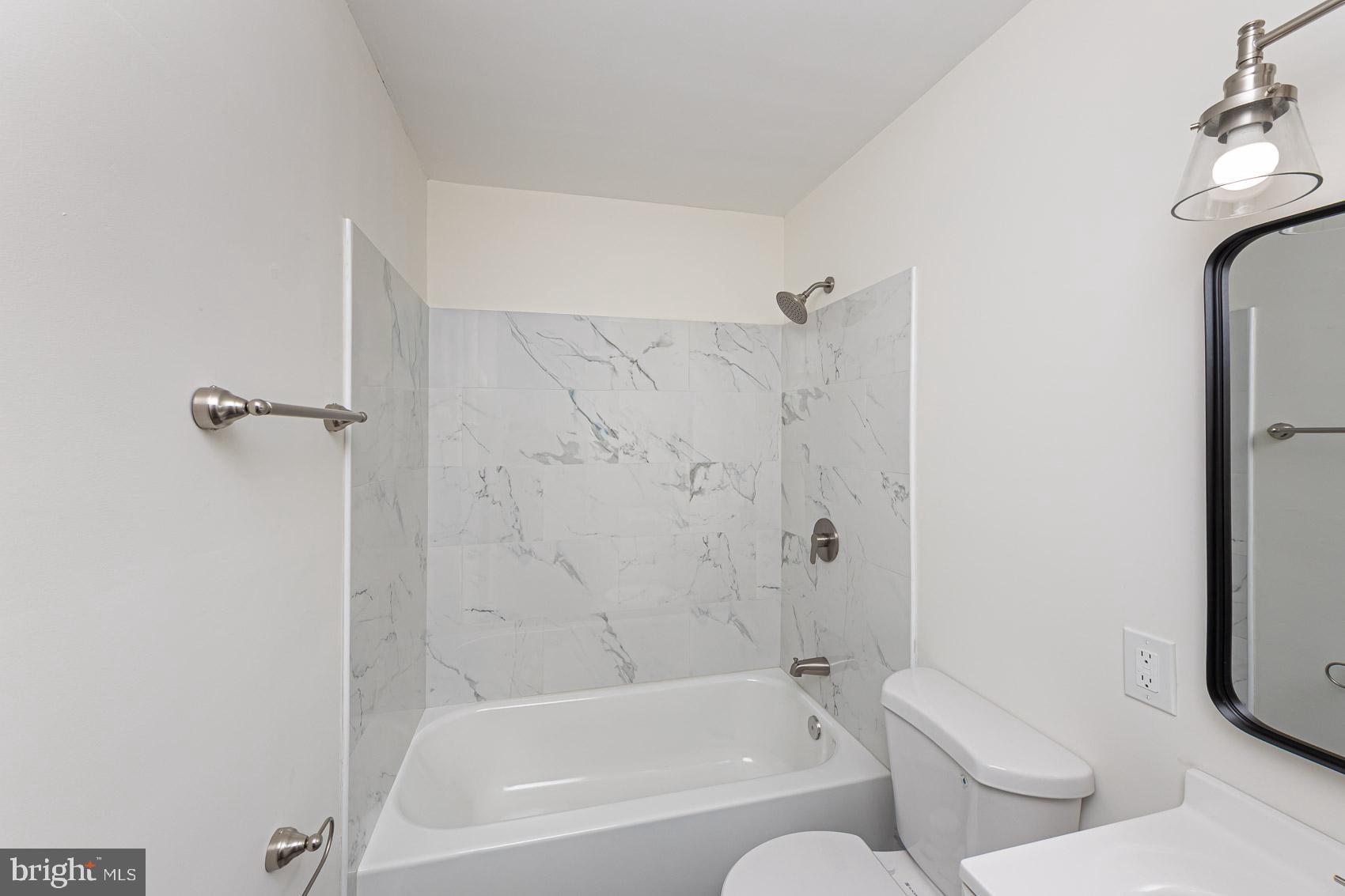 7035 Gough Street Baltimore, MD 21224 - Photo 18 of 25 a bathroom with a bathtub and shower